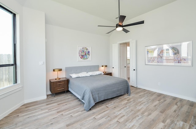 bedroom with ceiling fan, light wood-type flooring, baseboards, and vaulted ceiling