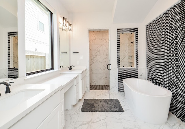 full bathroom featuring a sink, a freestanding tub, marble finish floor, and a shower stall