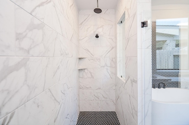 bathroom featuring tiled shower and a freestanding tub