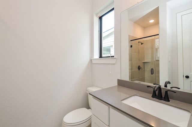 full bath with vanity, toilet, and tiled shower