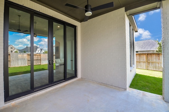 view of patio / terrace with a ceiling fan and fence