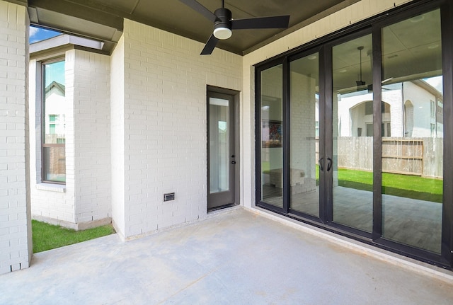 view of patio featuring a ceiling fan and fence