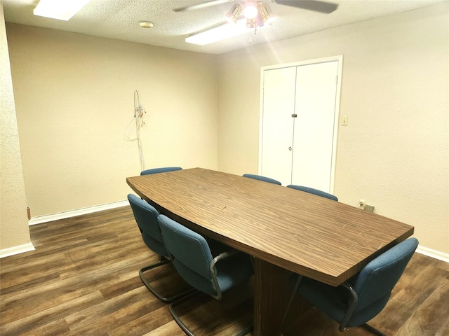 office with baseboards, a textured ceiling, ceiling fan, and dark wood-style floors