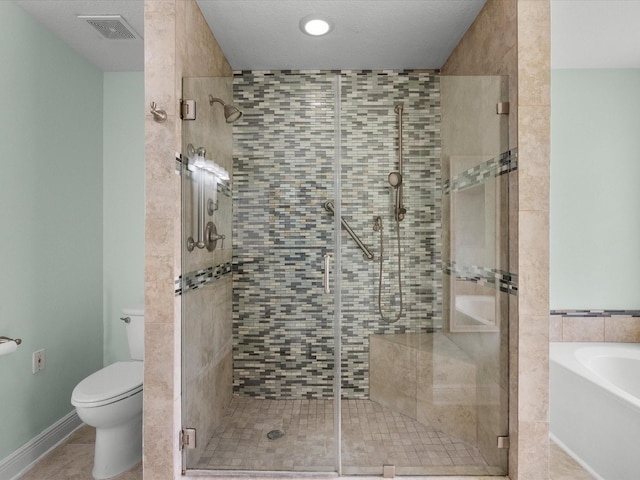 bathroom with visible vents, toilet, tile patterned flooring, a shower stall, and a bath