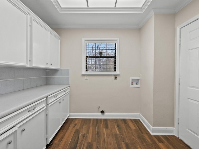 clothes washing area featuring washer hookup, dark wood finished floors, cabinet space, and baseboards