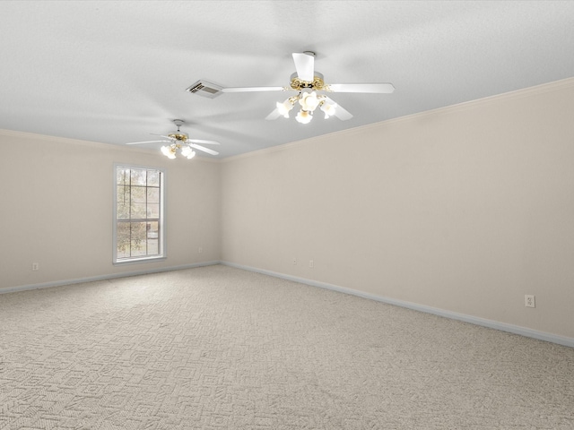 carpeted spare room featuring ornamental molding, visible vents, ceiling fan, and baseboards