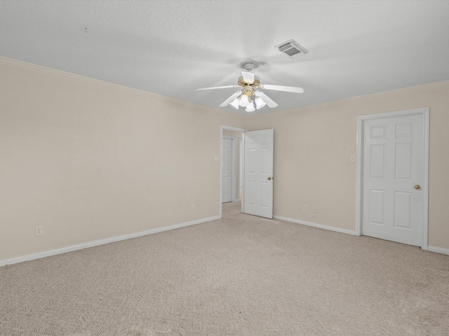 unfurnished room with ornamental molding, visible vents, light carpet, and baseboards