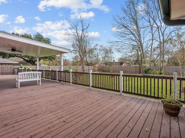 deck with a fenced backyard, a lawn, and ceiling fan