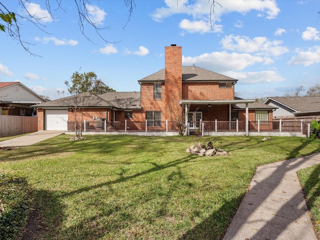 rear view of house with a lawn, a chimney, an attached garage, covered porch, and brick siding