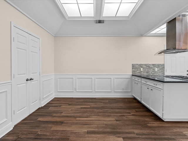 kitchen featuring dark countertops, island exhaust hood, dark wood finished floors, and white cabinets