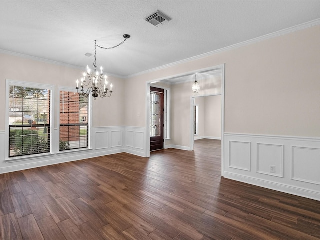 unfurnished dining area with a textured ceiling, dark wood-style flooring, visible vents, and a notable chandelier