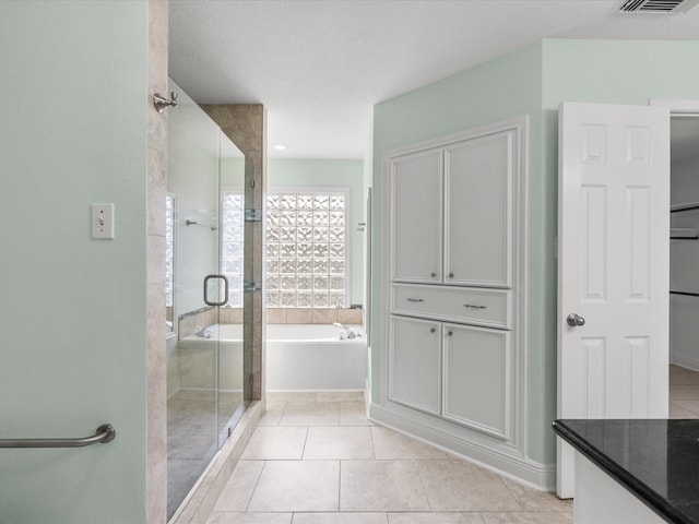 full bath with a garden tub, vanity, visible vents, tile patterned floors, and a stall shower