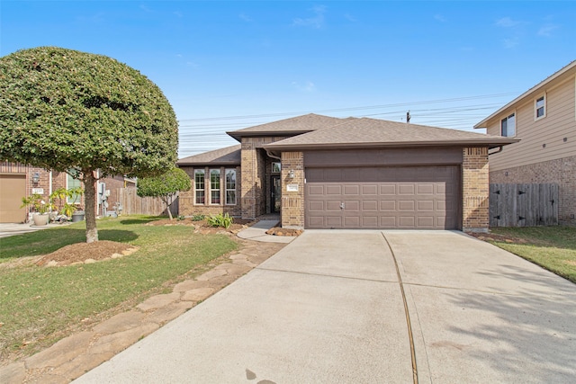 view of front of home with brick siding, concrete driveway, an attached garage, a front yard, and fence