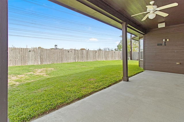 view of yard featuring a patio area, a fenced backyard, and a ceiling fan