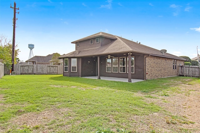 back of house with a patio area, a fenced backyard, brick siding, and a yard