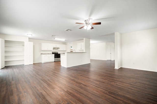 unfurnished living room featuring dark wood-style flooring, visible vents, ceiling fan, and baseboards