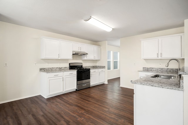 kitchen featuring white cabinets, range with gas stovetop, light stone countertops, under cabinet range hood, and a sink