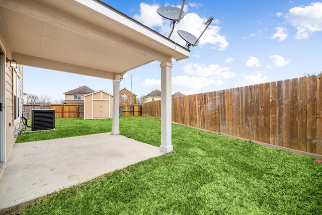 view of yard with an outbuilding, a patio, central air condition unit, a storage shed, and a fenced backyard