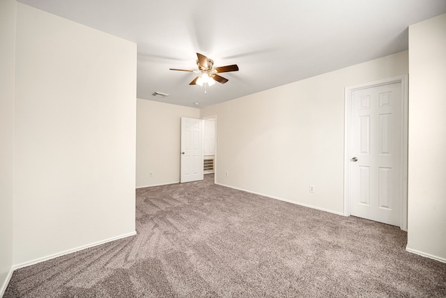 unfurnished room featuring visible vents, carpet flooring, a ceiling fan, and baseboards