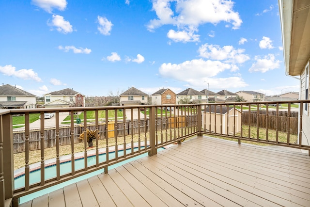 deck with a fenced backyard, a residential view, and a fenced in pool