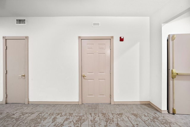 unfurnished room with light carpet, baseboards, and visible vents