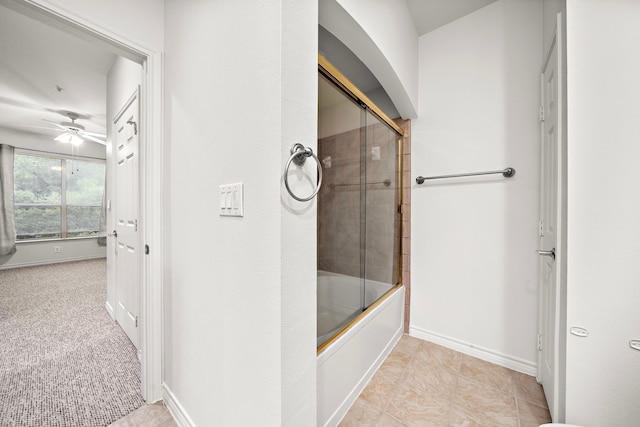 full bath with a ceiling fan, baseboards, and bath / shower combo with glass door