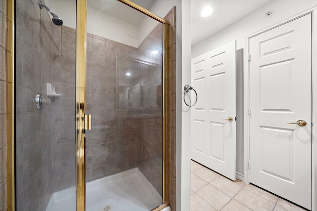 full bath with a stall shower and tile patterned floors