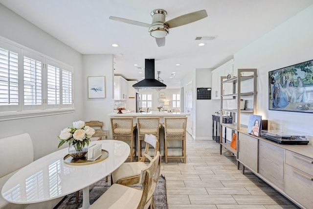 dining space featuring baseboards, visible vents, a ceiling fan, wood finish floors, and recessed lighting