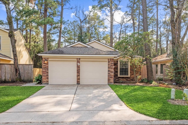 view of front of house featuring a garage, driveway, brick siding, and fence