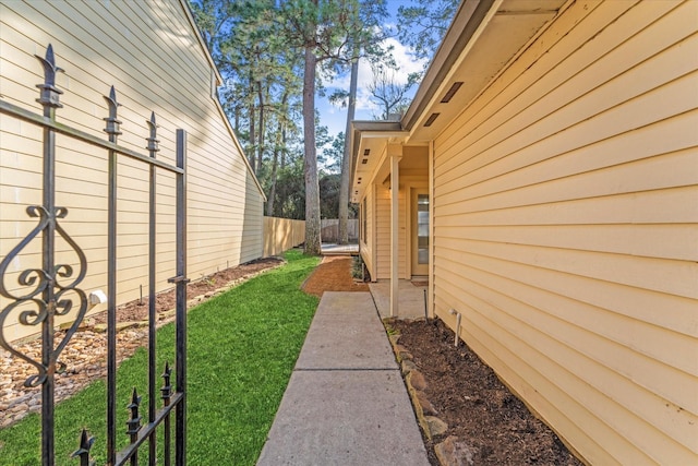 view of property exterior featuring fence and a yard