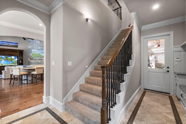 stairway featuring ornamental molding, recessed lighting, and baseboards