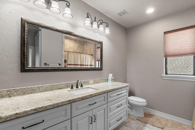 bathroom with visible vents, baseboards, toilet, tile patterned floors, and vanity