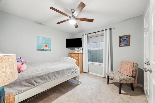 bedroom featuring light carpet, ceiling fan, and baseboards