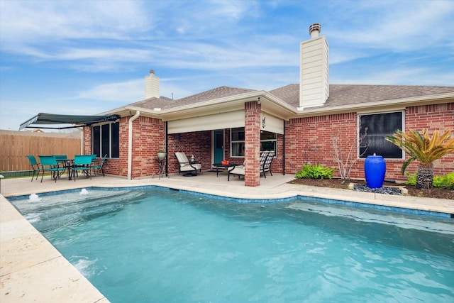 view of swimming pool featuring a patio, fence, and a fenced in pool