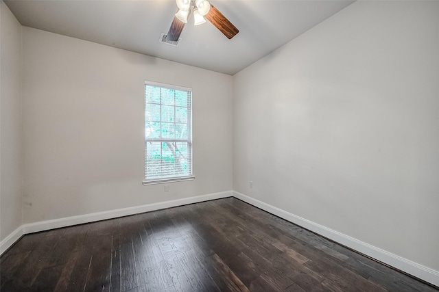 unfurnished room featuring dark wood-style floors, ceiling fan, visible vents, and baseboards