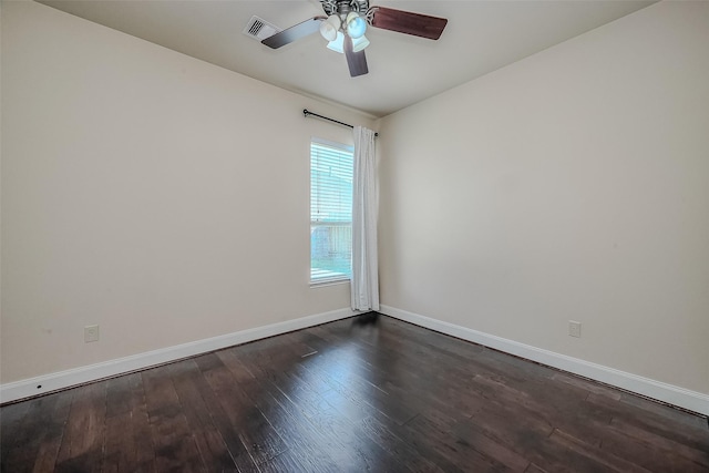 unfurnished room featuring dark wood-style floors, ceiling fan, visible vents, and baseboards