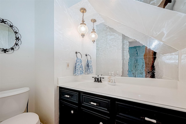 half bathroom with vanity and toilet