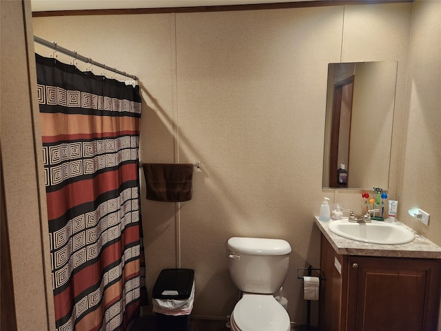 bathroom featuring curtained shower, vanity, and toilet