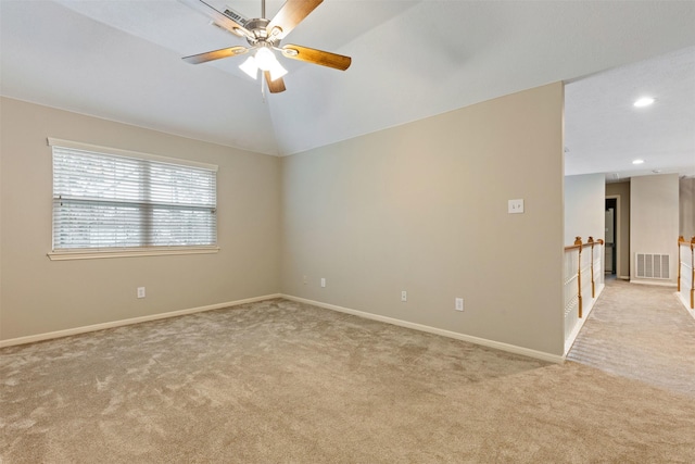 spare room featuring lofted ceiling, visible vents, light carpet, and recessed lighting