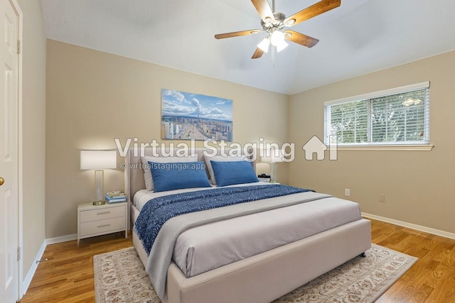 bedroom featuring baseboards, a ceiling fan, and light wood-style floors