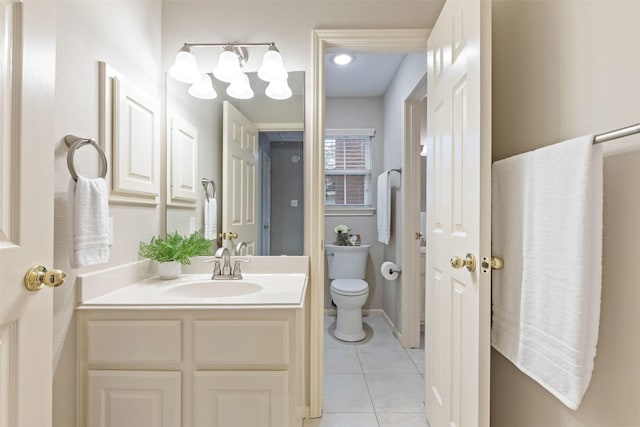 bathroom featuring tile patterned flooring, vanity, and toilet