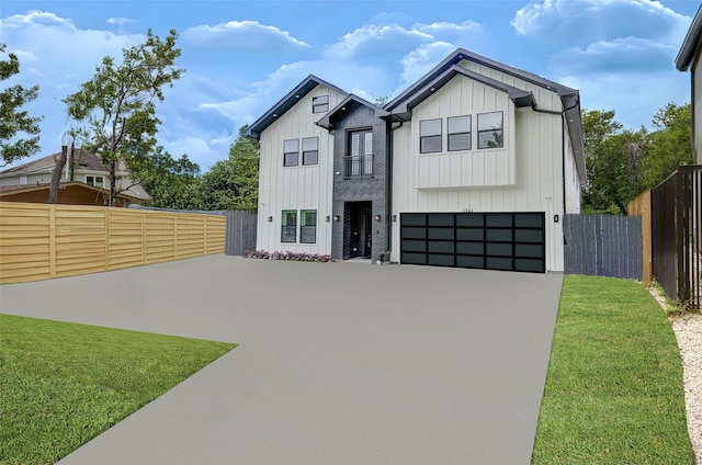 modern inspired farmhouse featuring concrete driveway, an attached garage, fence, board and batten siding, and a front yard