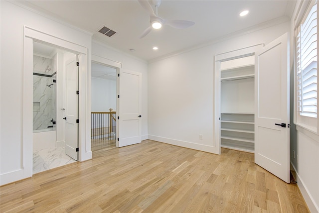 unfurnished bedroom featuring ornamental molding, visible vents, and light wood-style floors