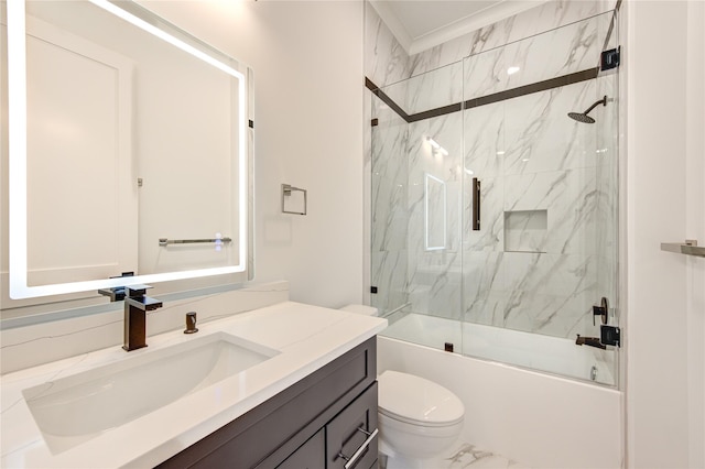 bathroom featuring toilet, marble finish floor, bath / shower combo with glass door, and vanity