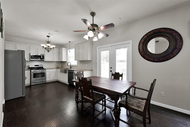 dining space featuring baseboards, visible vents, dark wood-style flooring, french doors, and ceiling fan with notable chandelier