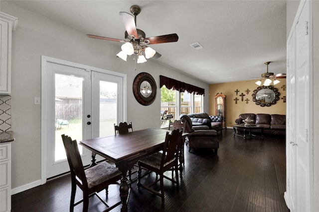 dining space featuring french doors, dark wood finished floors, visible vents, ceiling fan, and baseboards