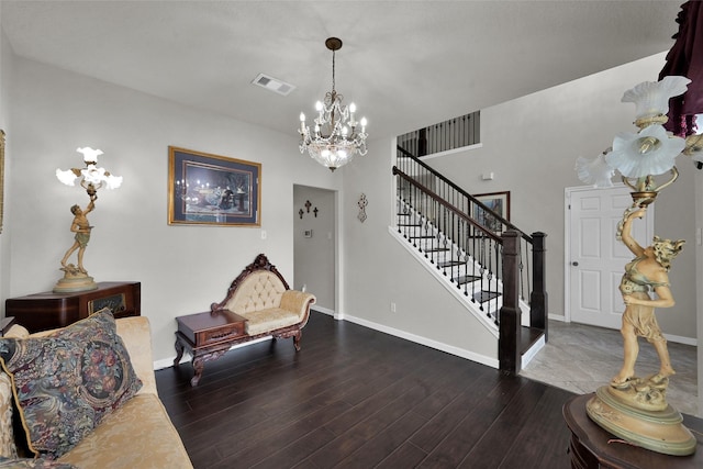 sitting room featuring baseboards, visible vents, dark wood-style flooring, an inviting chandelier, and stairs