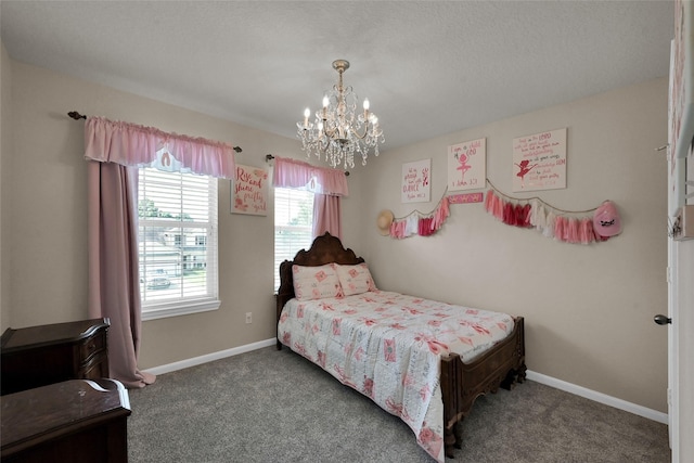 bedroom featuring a notable chandelier, dark carpet, and baseboards