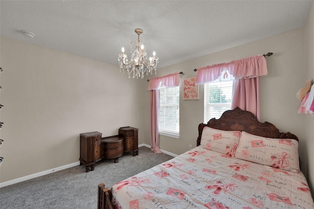 bedroom with a notable chandelier, baseboards, and carpet flooring