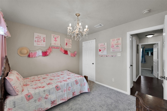 bedroom featuring baseboards, visible vents, dark colored carpet, and a notable chandelier